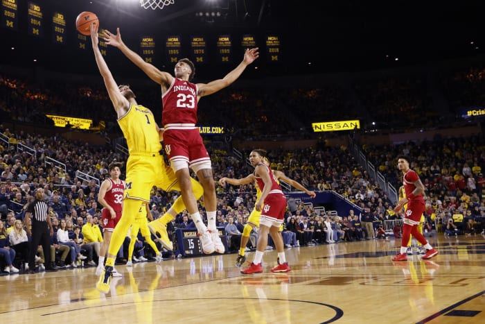 Michigan Wolverines center Hunter Dickinson (1) and Indiana Hoosiers forward Trayce Jackson-Davis (23) battle for the ball in the first half at Crisler Center.